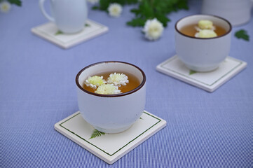 still life with white chrysanthemum tea on the table