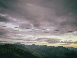 Dark cloudy sky over distant mountains
