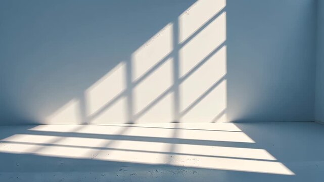 Shadow Play in Architectural Space: A modern architectural space is bathed in the play of light and shadow, where sun rays cascade through a window, casting graphic patterns on the wall.