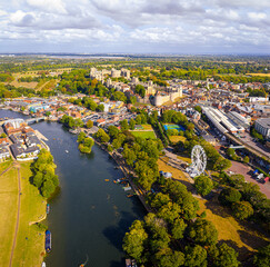Aerial view of Windsor Castle surrounded by town buildings and lush green landscape