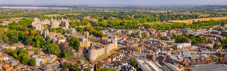 Aerial view of Windsor Castle surrounded by town buildings and lush green landscape