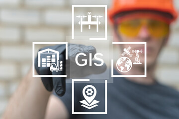 Engineer in hard hat using virtual touch screen presses the abbreviation GIS. GIS Geographic Information System Modern Industry 4.0 Software Database Transportation Tracking Concept. © wladimir1804