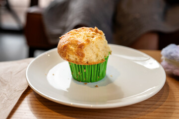 half-eaten muffin on white plate in cafe. High quality photo