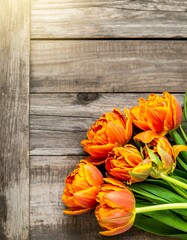Orange tulips on weathered wood