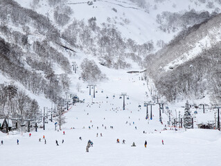 Busy winter scene at Hakuba Goryu ski resort in Nagano, Japan with many skiers