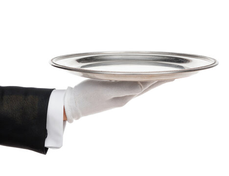 A hand in a white glove holds a silver platter