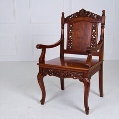 Ornate carved wooden armchair