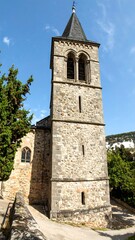 Fototapeta premium Historic stone church tower under blue sky
