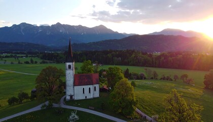 Panoramic view of a church nestled in a valley at sunset