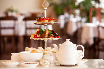 Traditional British afternoon high tea with delicious treats and fine tea.