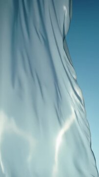 Pristine, unbranded, semi-translucent ripstop nylon fabric billows dynamically against a bright minimalist studio or clear sky with soft backlighting. Concept of resilience