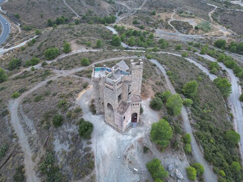 Aerial drone view of Castillo del Agua in Alhaurin de la Torre, Malaga, Spain, with dramatic cloudy sky