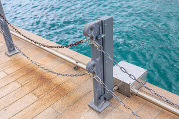 Urban Waterfront with Metal Chain Railing and Water