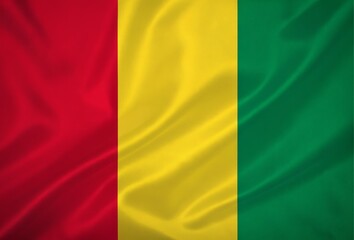Obraz premium Close up of the national flag of guinea waving in the wind proudly