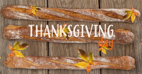 Image of thanksgiving day text over autumn leaves and baguettes on wooden boards