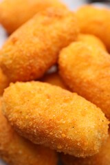 Many delicious fried croquettes as background, closeup