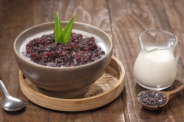 Bubur ketan hitam, bubur injit, bubur pulut hitam. Black sticky rice porridge is a dessert, with a sweet taste, made from sticky rice boiled with excess water until soft, and usually served with cocon