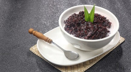 Bubur ketan hitam, bubur injit, bubur pulut hitam. Black sticky rice porridge is a dessert, with a sweet taste, made from sticky rice boiled with excess water until soft, and usually served with cocon