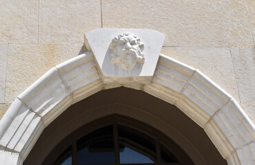 Dramatic  European Architectural Stone Relief of Head Carving Keystone over Limestone Archway on Building 