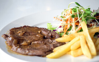 Close up of Grilled beef steak, boiled french fries and vegetable salad;Selective focus