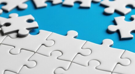 Obraz premium Business Solution Concept: White Puzzle Pieces on a Bright Blue Background with Copy Space