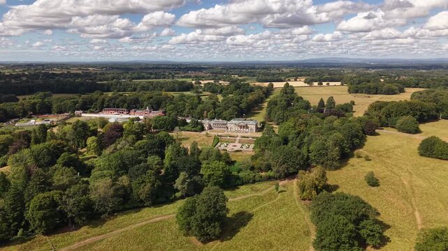 Drone view of a historic country estate surrounded by dense woodland and open fields