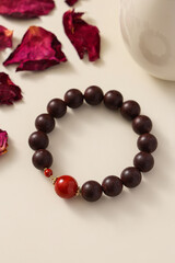 A wooden bead bracelet laid flat, showcasing natural materials and craftsmanship,is an accessory that can be worn on the wrist or ankle