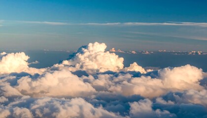 High-altitude view of puffy white clouds against a clear blue sky