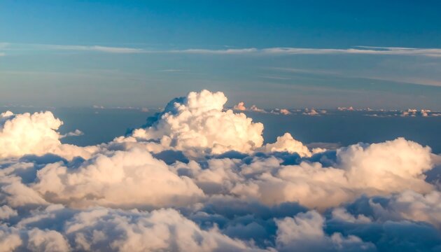 High-altitude view of puffy white clouds against a clear blue sky