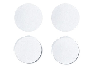 Four blank, circular, white placemats or coasters. Each has a slightly textured surface and a scalloped edge