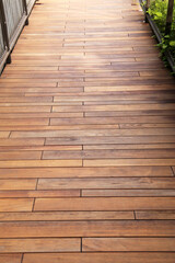 Outdoor wooden walkway surface with natural grain and warm brown tones.