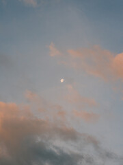 Moon and Clouds in the Evening Sky with Soft Sunset Colors