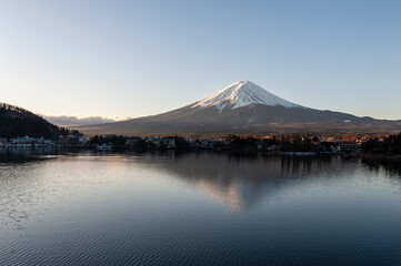 Mount Fuji on a bright winter morning, as seen from across lake Kawaguchi, and the nearby town of Kawaguchiko.