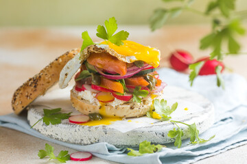 Bagel with salmon, egg, and fresh greens
