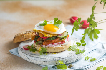 Bagel with salmon, egg, and fresh greens