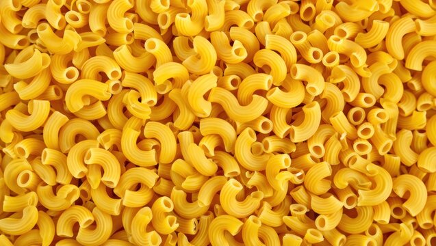 Abundant pile of uncooked elbow macaroni pasta with a warm glow - Powered by Adobe