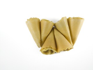 Semprong cake, sapit, sepit, Dutch cake, gapit, kassipi, kapit, Asian egg roll. A waffle or pastry snack originating from Indonesia. Semprong cake isolated on a white background.