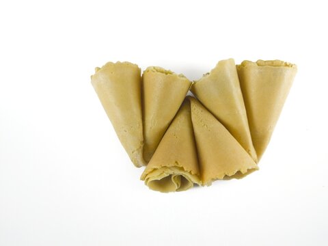 Semprong cake, sapit, sepit, Dutch cake, gapit, kassipi, kapit, Asian egg roll. A waffle or pastry snack originating from Indonesia. Semprong cake isolated on a white background.
