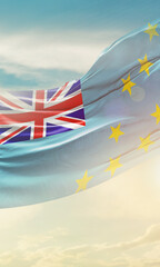Tuvalu national flag for poster. The flag waving in beautiful clouds with vertical layout. Tuvalu...