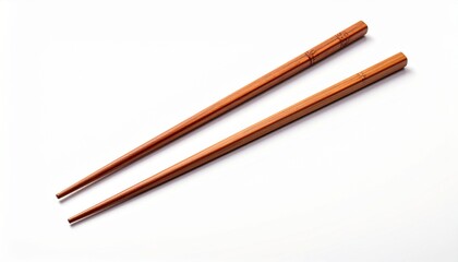 A pair of wooden chopsticks on a clean white backdrop, shot with a diagonal perspective.