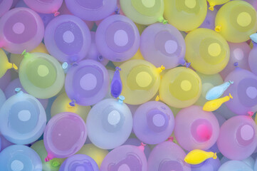 Colorful collection of pastel water balloons floating together