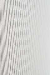 Obraz premium A white papers with a pattern of horizontal lines. The lines are evenly spaced and appear to be made of a material that is not very thick