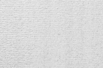 A grey wall with a white stripe. The wall is made of concrete and has a rough texture