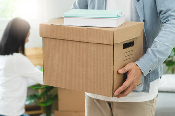 People relocation move home concept, Man carrying belongings box moving in new apartment.