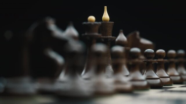 Close up of vintage black chess pieces on a chessboard
