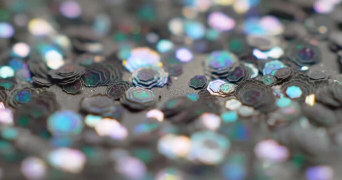 Colorful sequins scattered on a textured surface