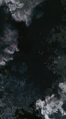 Obraz premium Aerial view of dark water surrounded by lush, green vegetation, with scattered red boats. The lighting is dramatic, creating a moody, serene atmosphere