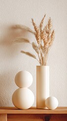 Simple arrangement dried wheat in vase, stacked spheres, and a lone sphere, against a textured wall with soft shadows, on a wood shelf
