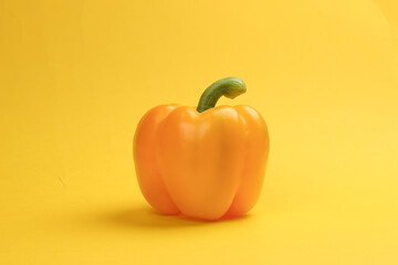 Capsicum bell pepper red yellow on yellow background