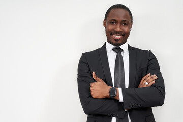 Smiling african businessman with thumbs up over grey background with copy space